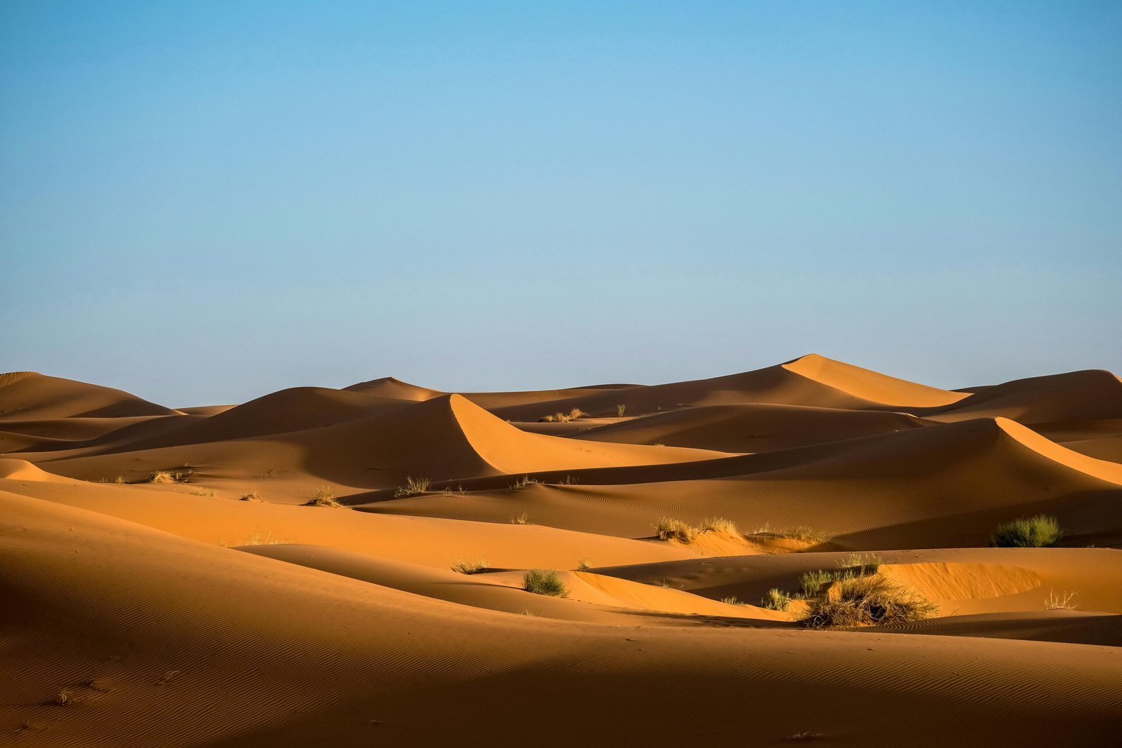 Scenic view of Sahara Desert sand dunes in Morocco showcasing natural beauty and tranquility.
